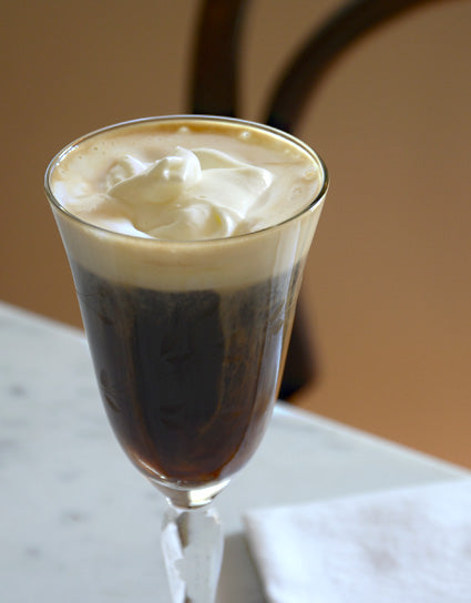 Stemmed glass of Wine Forest Candy Cap Irish coffee topped with whipped cream